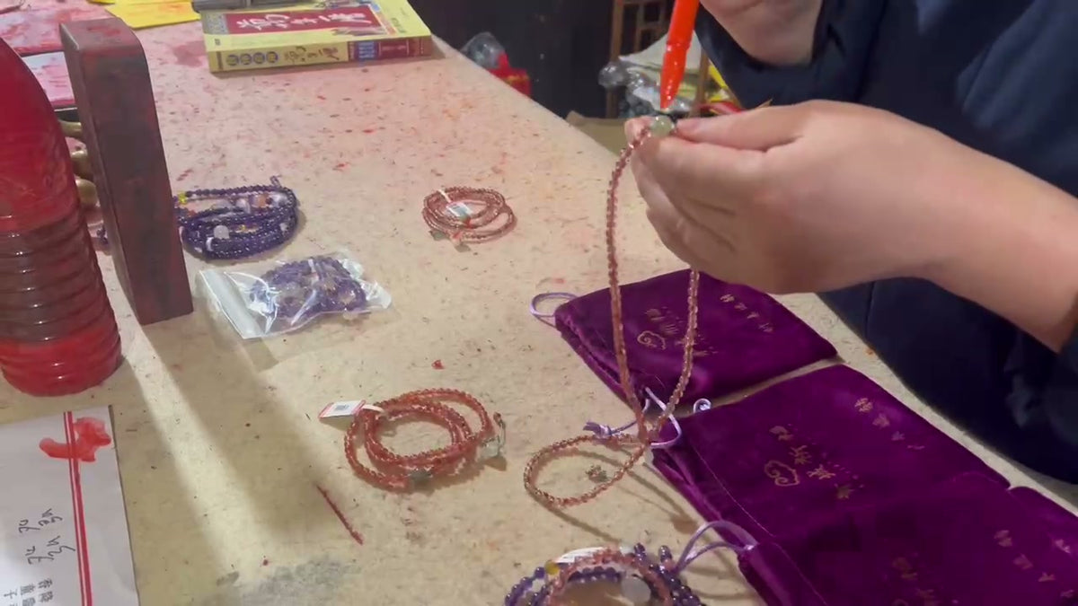Hands arranging a bracelet in the real ritual